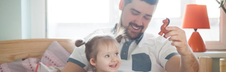 Dad and daughter on bed